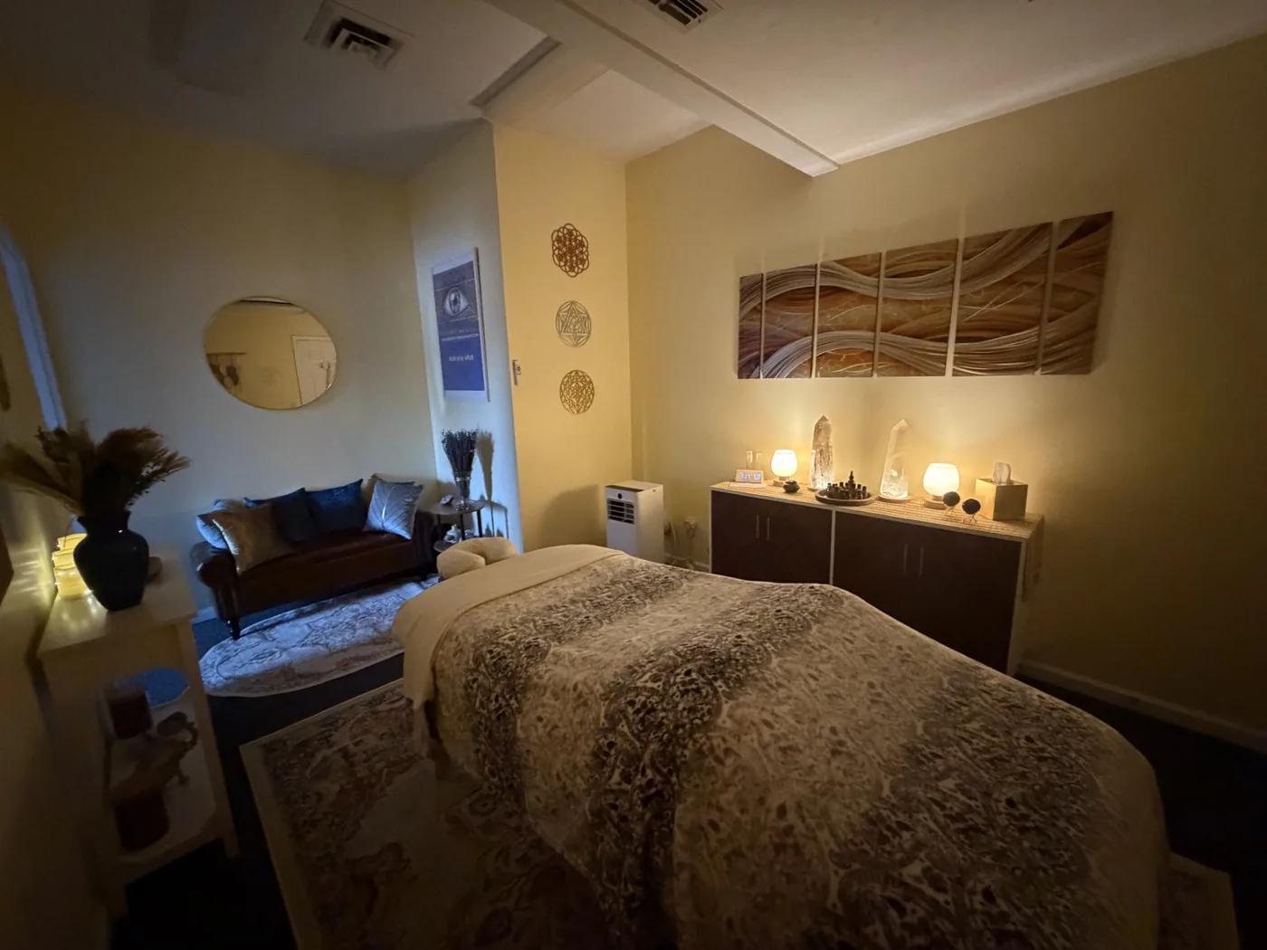 Treatment room at Indigo Bodywork and Massage, warm lamplight and a draped massage table